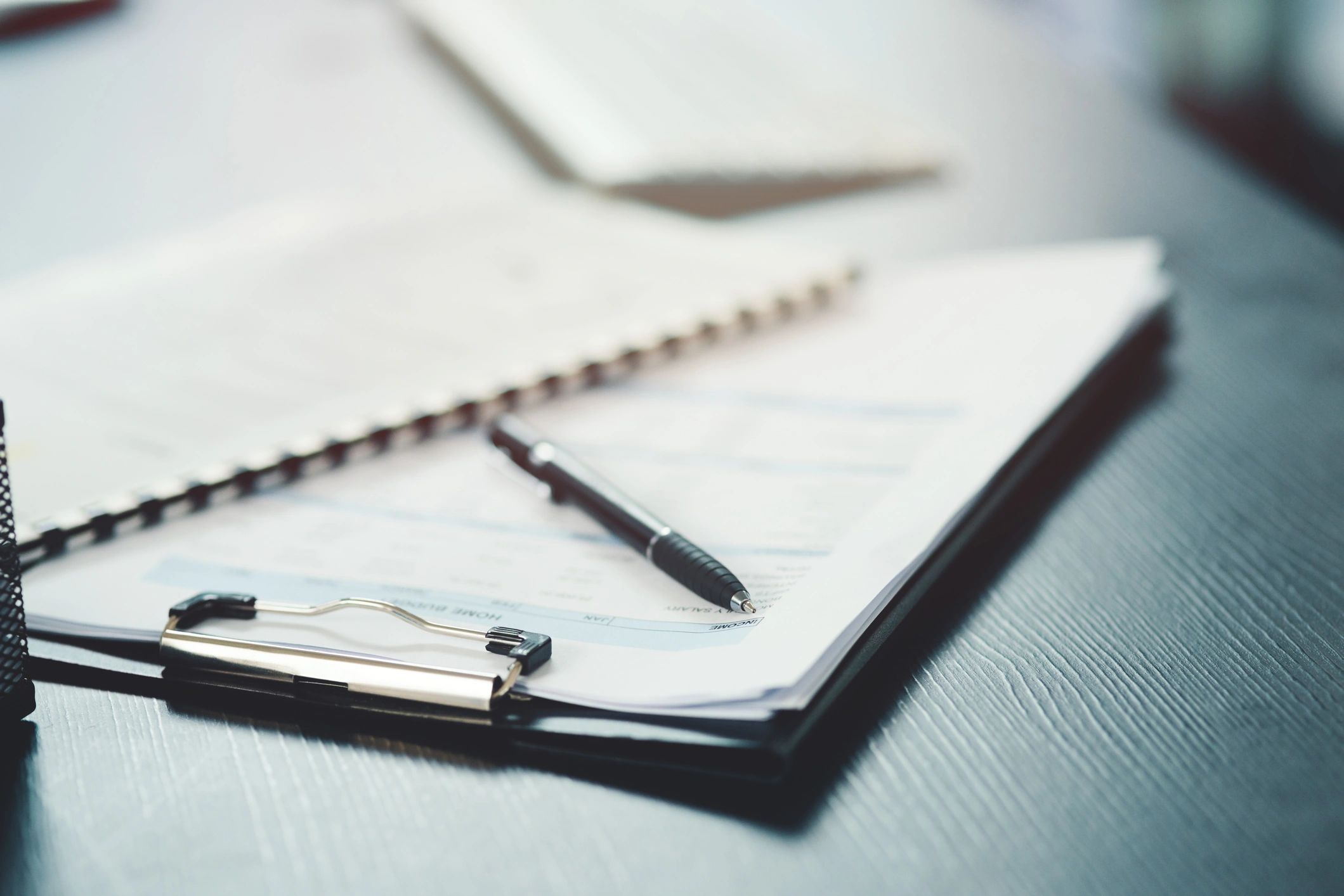 Organized legal documents and pen on an office desk
